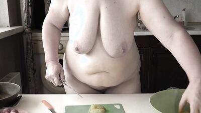 Naked mature bbw housewife with big saggy tits is cooking in the kitchen.