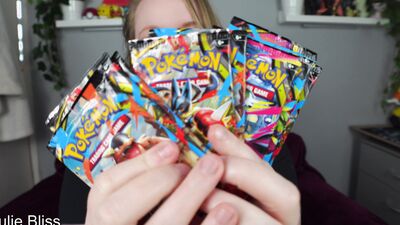 Blonde gamer joins behind the scenes of a Pokemon Card Unboxing with nerdy cosplay girl Julie Bliss