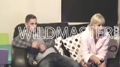Blonde girl and her boyfriend are cuddling on the couch