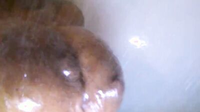 Spicy black chick gets horny under the shower and plays with herself