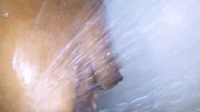 Spicy black chick gets horny under the shower and plays with herself