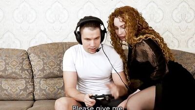 Mature woman is flirting with the camera while blowing her stepson