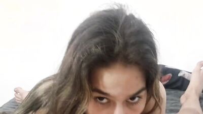 Pretty girl stares at the camera while sucking a big cock